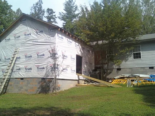 Tyvek wrapped gable on a new room addition beside an existing home in New Smyrna Beach